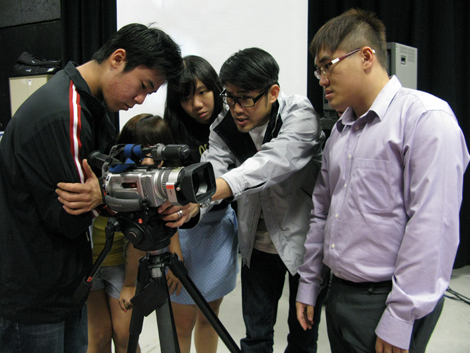Students getting hands-on experience with video production equipment