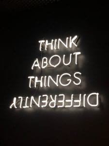 Neon lights spelling out: Think about things differently [with differently flipped horizontally]